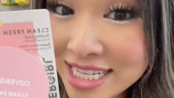 TikToker @beau.thi.ful holding up a Cover Girl makeup powder compact in a Dollar Tree store