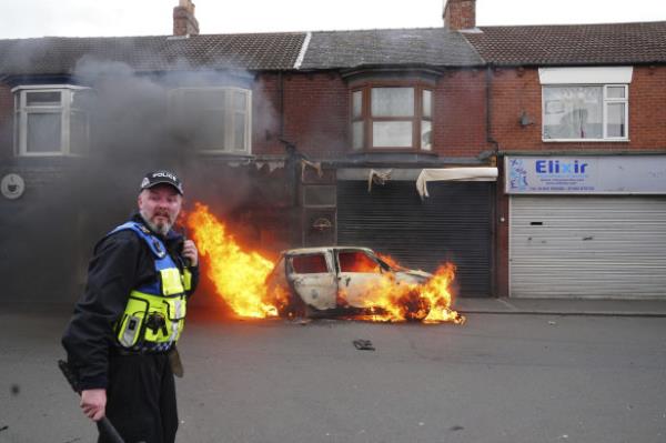 A car burns on Parliament Road in Middlesbrough during an anti-immigration protest.