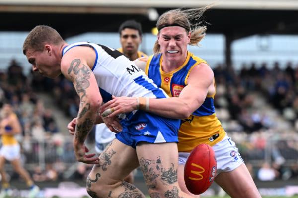 Eagle Harley Reid tackles Kangaroo forward Cameron Zurhaar.